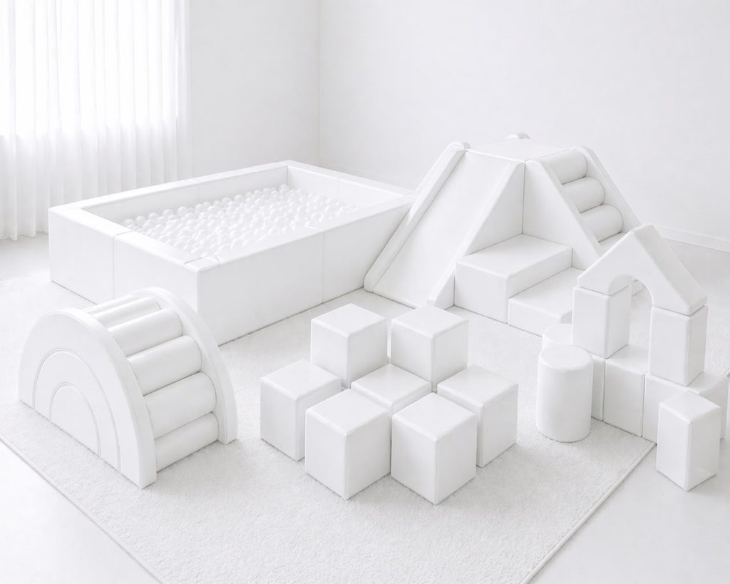 All-white soft play with ball pit, pyramid climber, rainbow arch and building blocks