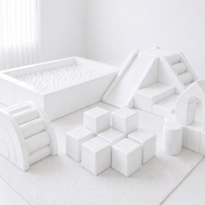All-white soft play with ball pit, pyramid climber, rainbow arch and building blocks