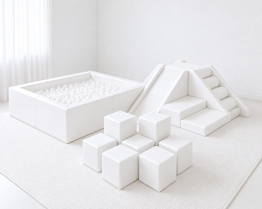 All-white soft play with ball pit, pyramid climber and nine building blocks